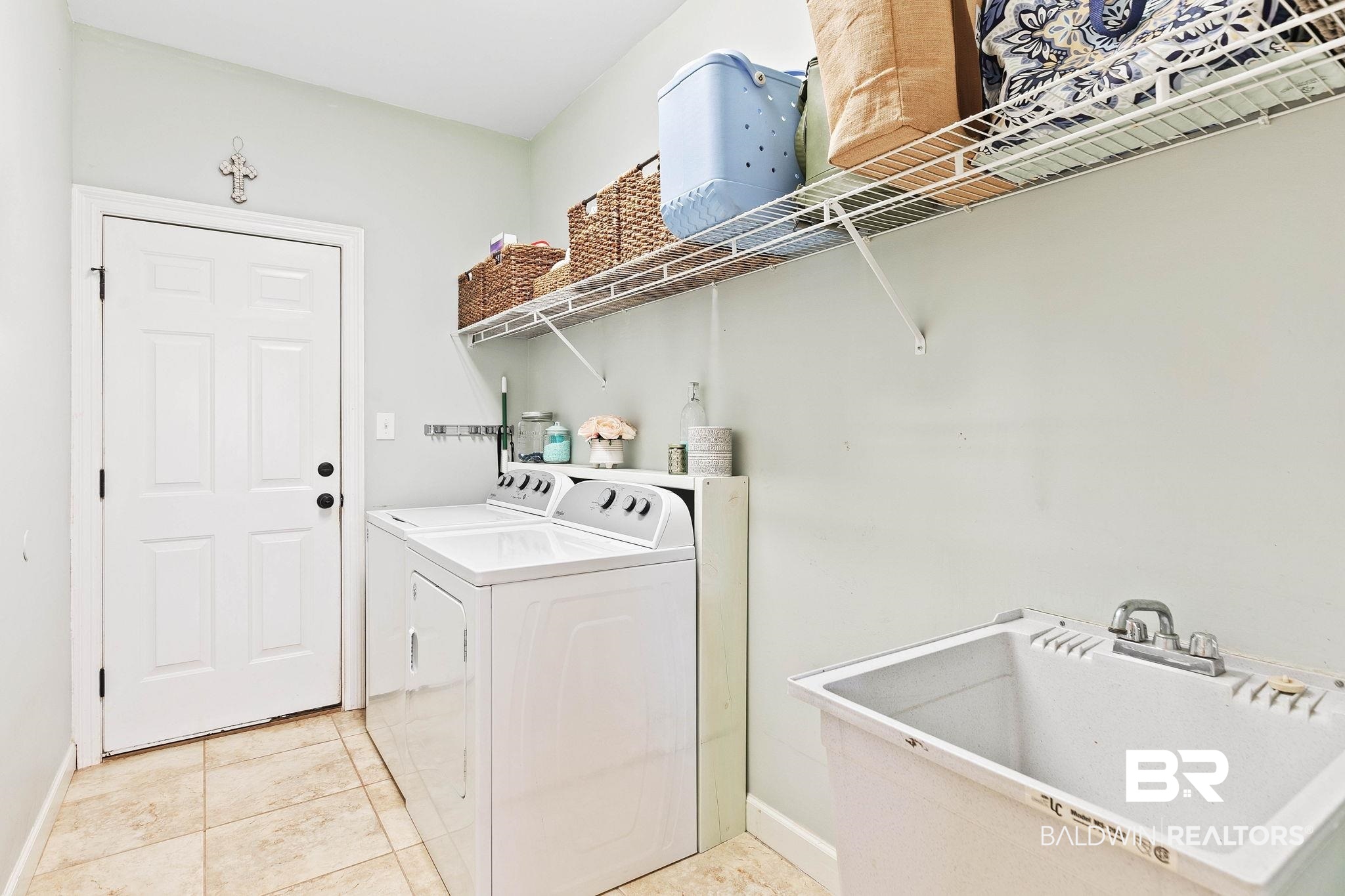 9522 Sanibel Loop Daphne, AL 36526 - Photo 25 of 43 Laundry area with light tile patterned flooring and independent washer and dryer