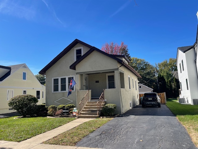 634 Spring Road Elmhurst, IL 60126 - Photo 1 of 15 a front view of a house with a yard