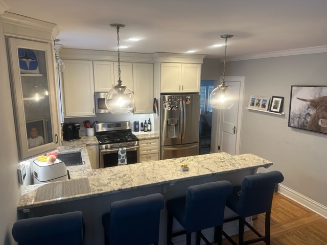 634 Spring Road Elmhurst, IL 60126 - Photo 5 of 15 a kitchen with stainless steel appliances kitchen island granite countertop a dining table chairs and refrigerator