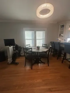 a living room with furniture a window and a piano