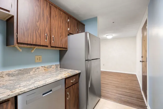 a kitchen with refrigerator and cabinets