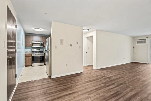 a view of a kitchen with a sink and a refrigerator