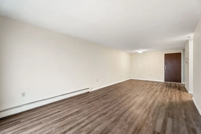 a view of an empty room and wooden floor