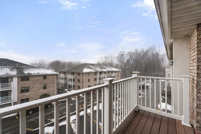 a view of a balcony with wooden fence and floor