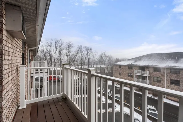 a view of a balcony with wooden fence and floor