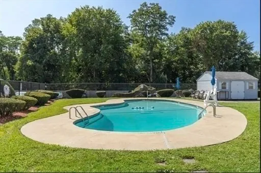 a view of a swimming pool with a yard