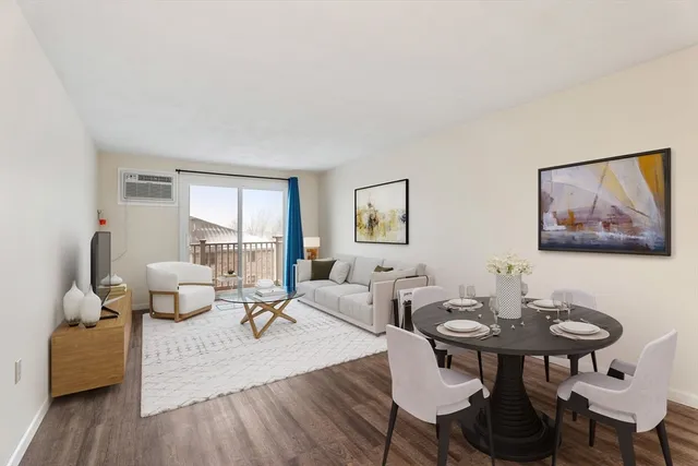 a living room with furniture and a painting on the wall