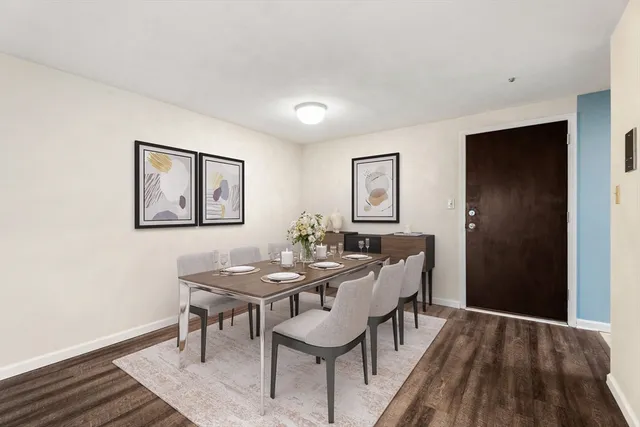 a view of a dining room with furniture and wooden floor