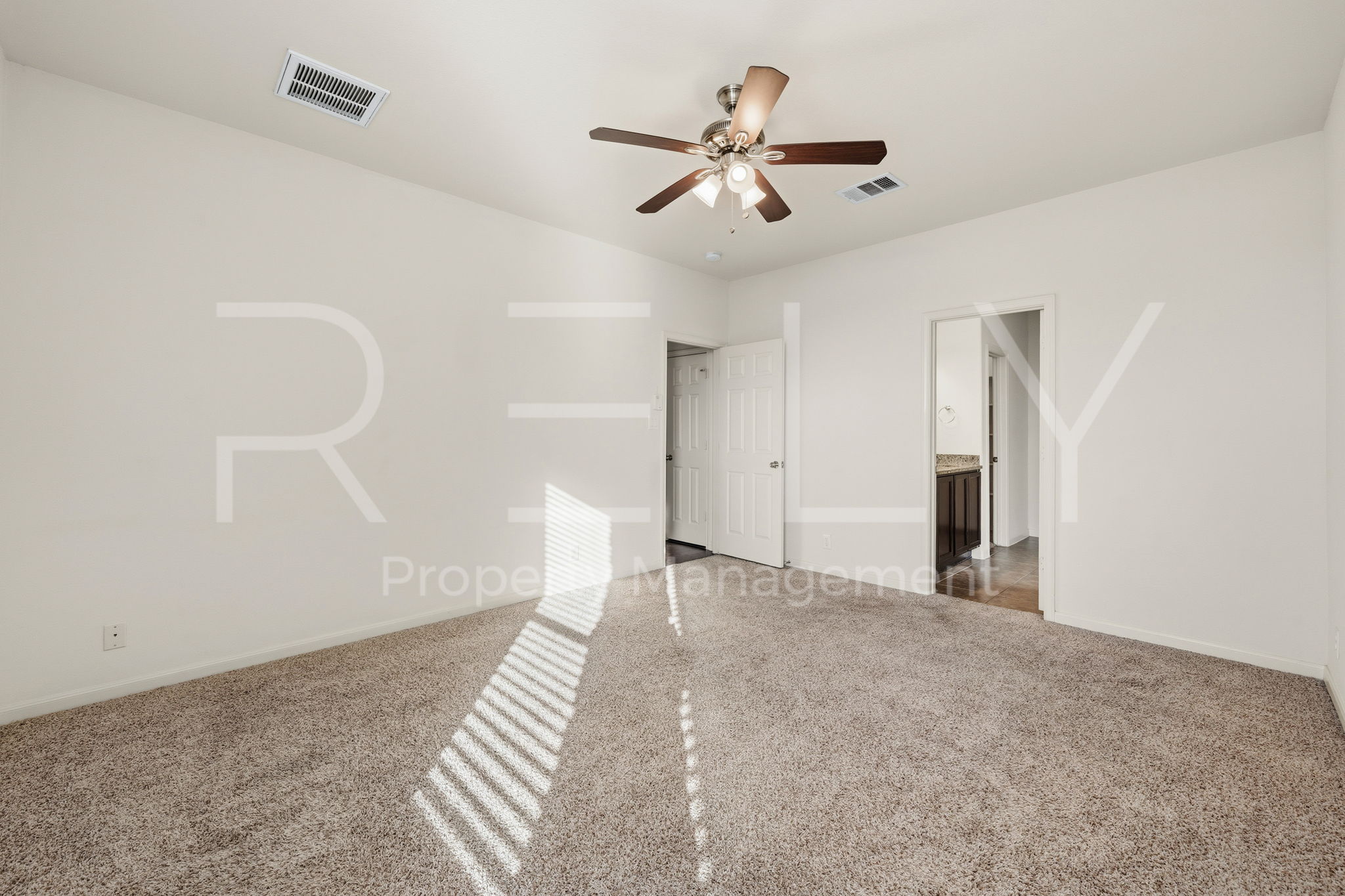 1405 Sunny Meadows Loop Georgetown, TX 78626 - Photo 16 of 40 A well-lit bedroom with plush carpeting and a ceiling fan offers comfortable living.