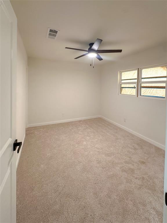 809 Longbeach Drive Garland, TX 75043 - Photo 13 of 18 Carpeted empty room featuring a ceiling fan and baseboards