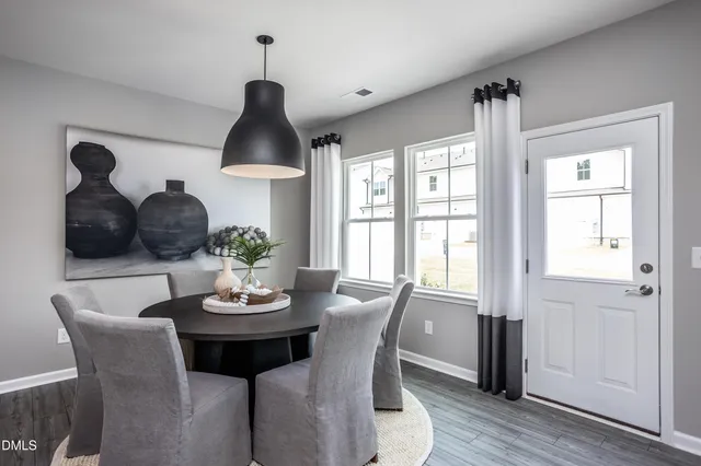 a kitchen with kitchen island a wooden floor and white cabinets