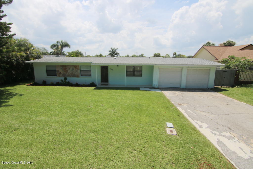 945 Trinidad Road Cocoa Beach, FL 32931 - Photo 1 of 34 a front view of house with yard and green space