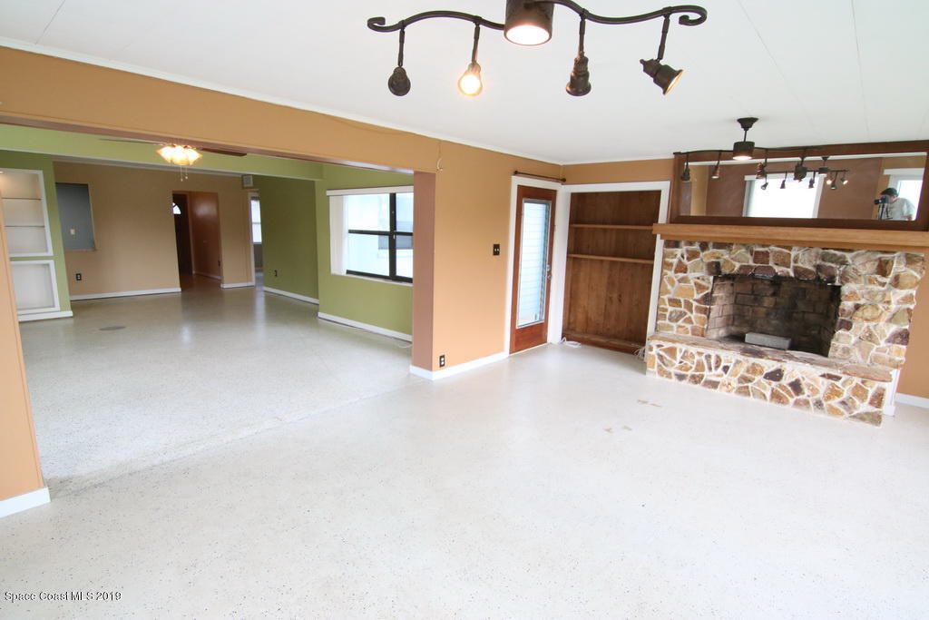 945 Trinidad Road Cocoa Beach, FL 32931 - Photo 12 of 34 a view of a livingroom with a fireplace
