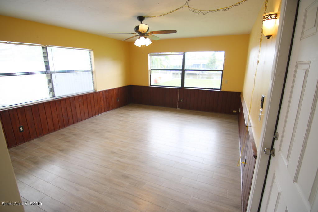 945 Trinidad Road Cocoa Beach, FL 32931 - Photo 20 of 34 wooden floor in an empty room with a window