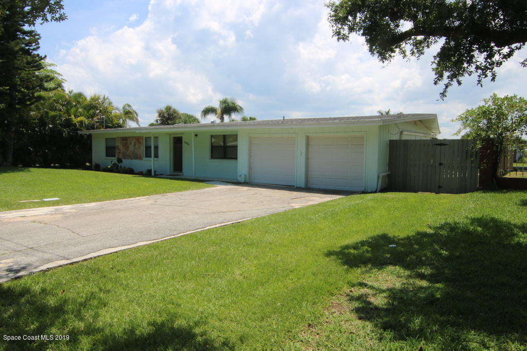 945 Trinidad Road Cocoa Beach, FL 32931 - Photo 3 of 34 a front view of a house with garden
