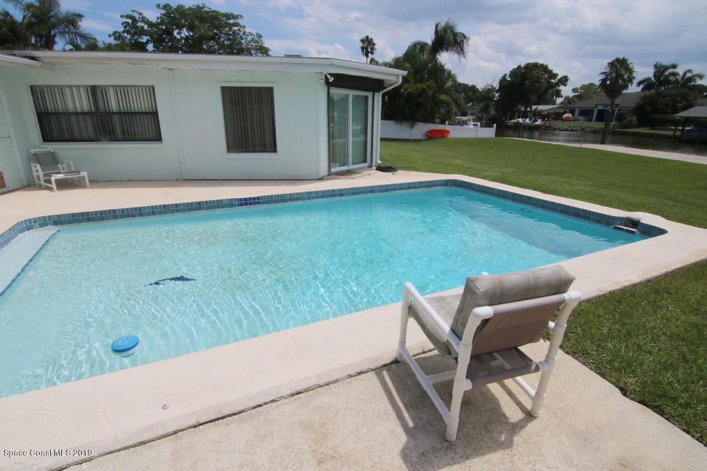 945 Trinidad Road Cocoa Beach, FL 32931 - Photo 24 of 34 a view of backyard with trampoline