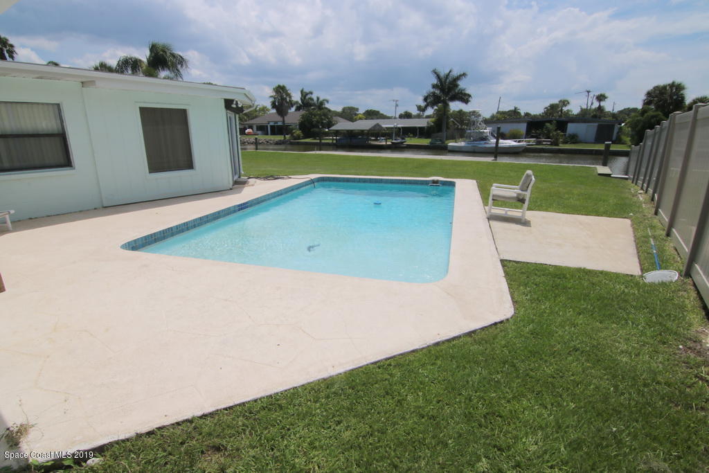 945 Trinidad Road Cocoa Beach, FL 32931 - Photo 25 of 34 a view of a swimming pool with outdoor space