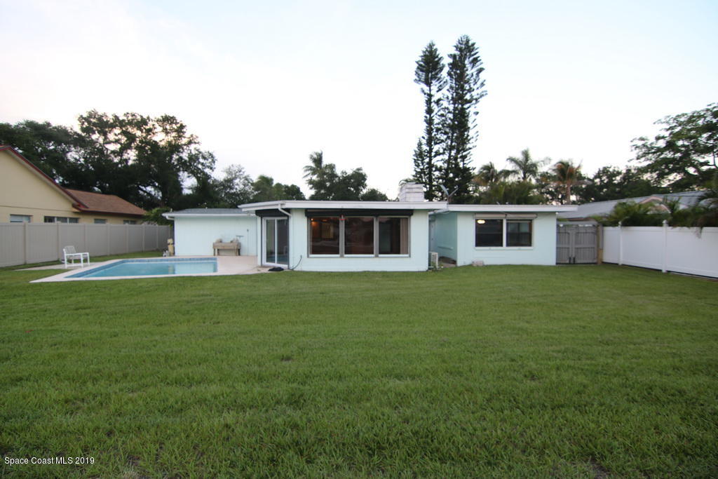 945 Trinidad Road Cocoa Beach, FL 32931 - Photo 28 of 34 a front view of house with yard and green space