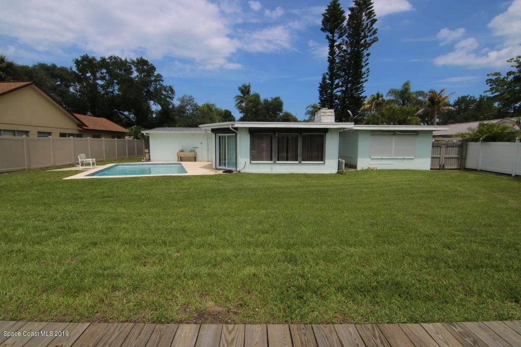 945 Trinidad Road Cocoa Beach, FL 32931 - Photo 29 of 34 front view of a house with a yard