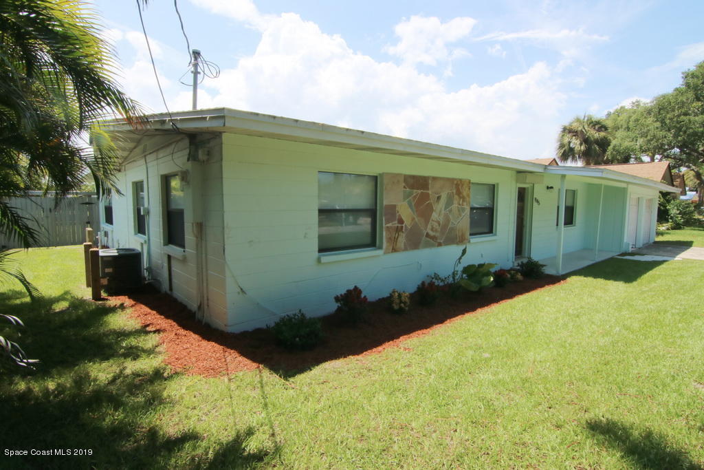 945 Trinidad Road Cocoa Beach, FL 32931 - Photo 4 of 34 a backyard of a house with yard and outdoor seating