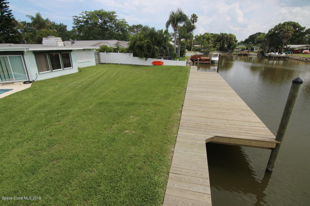 945 Trinidad Road Cocoa Beach, FL 32931 - Photo 31 of 34 a view of a lake with a house