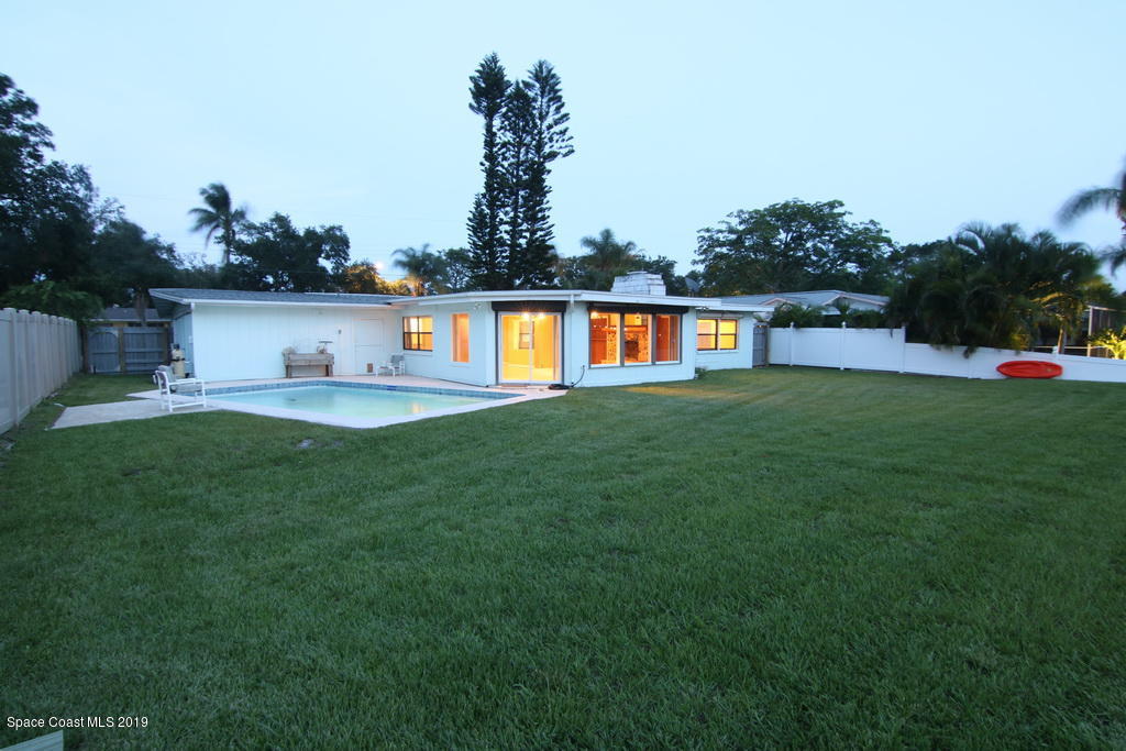 945 Trinidad Road Cocoa Beach, FL 32931 - Photo 32 of 34 a front view of a house with garden