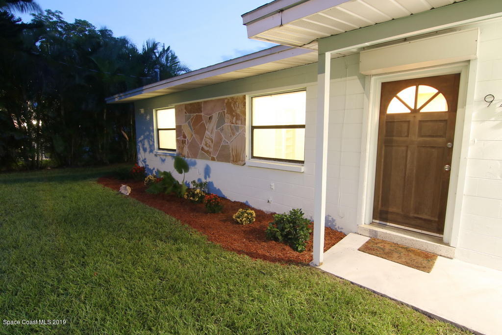 945 Trinidad Road Cocoa Beach, FL 32931 - Photo 5 of 34 a view of house with backyard and garden