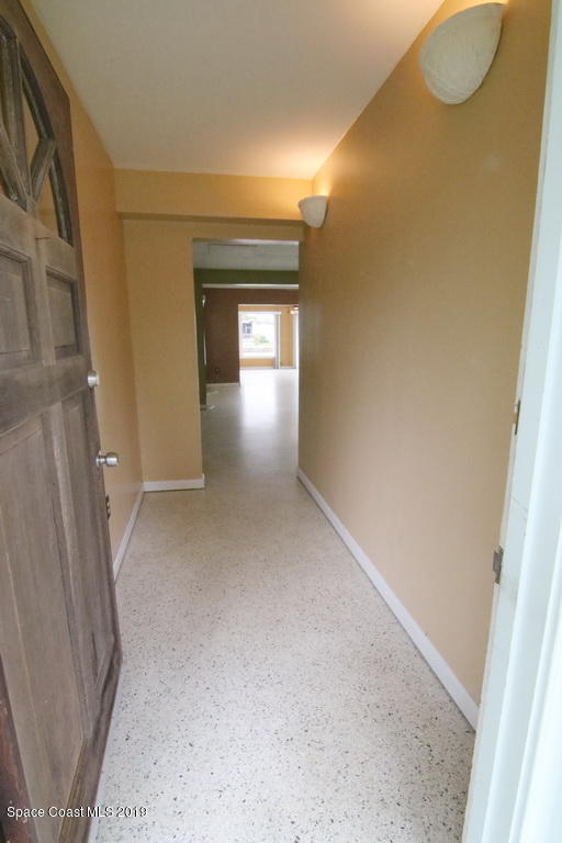 945 Trinidad Road Cocoa Beach, FL 32931 - Photo 6 of 34 a view of a hallway with wooden floor and closet