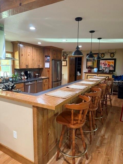 503 Bear Road Lake Placid, FL 33852 - Photo 13 of 29 a kitchen with stainless steel appliances granite countertop a kitchen island a stove a dining table and chairs with wooden floor