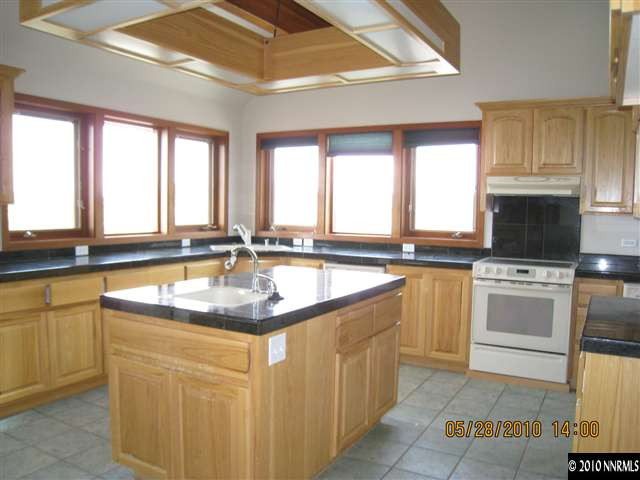 4520 Lousetown Road Reno, NV 89521 - Photo 3 of 9 a kitchen with stainless steel appliances granite countertop a sink and a stove