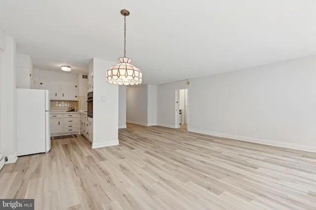a view of a room with wooden floor and a window
