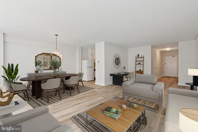 a living room with furniture a window and a table