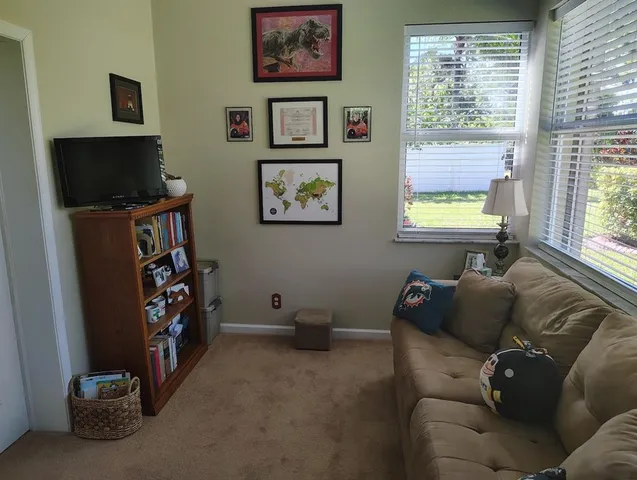 a view of a patio with a table chairs and a yard