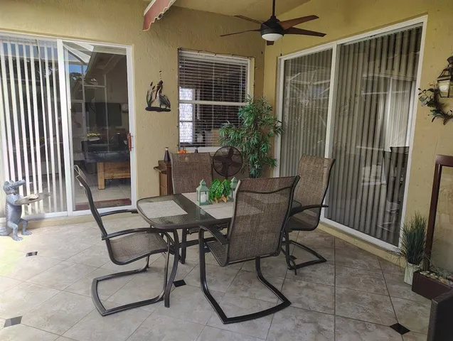 a view of a patio with chairs and a yard