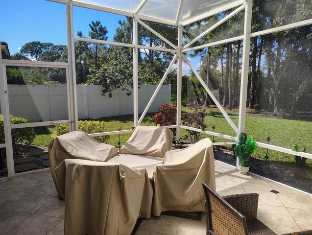 a view of a chairs and table in the patio