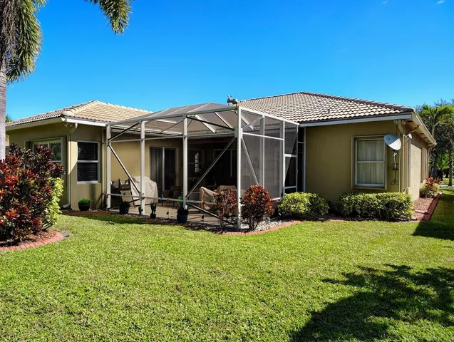 a view of a house with backyard porch and sitting area