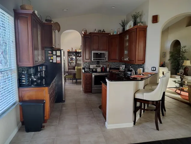 a bed sitting in a bedroom next to a lamp