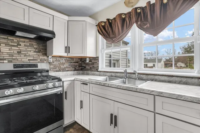 a kitchen with granite countertop a stove and a sink