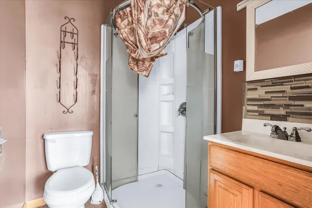 a bathroom with a toilet sink and shower