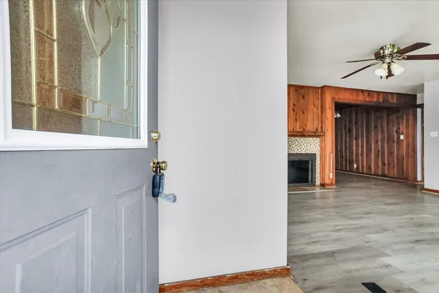 a view of a hallway with wooden floor and a fireplace