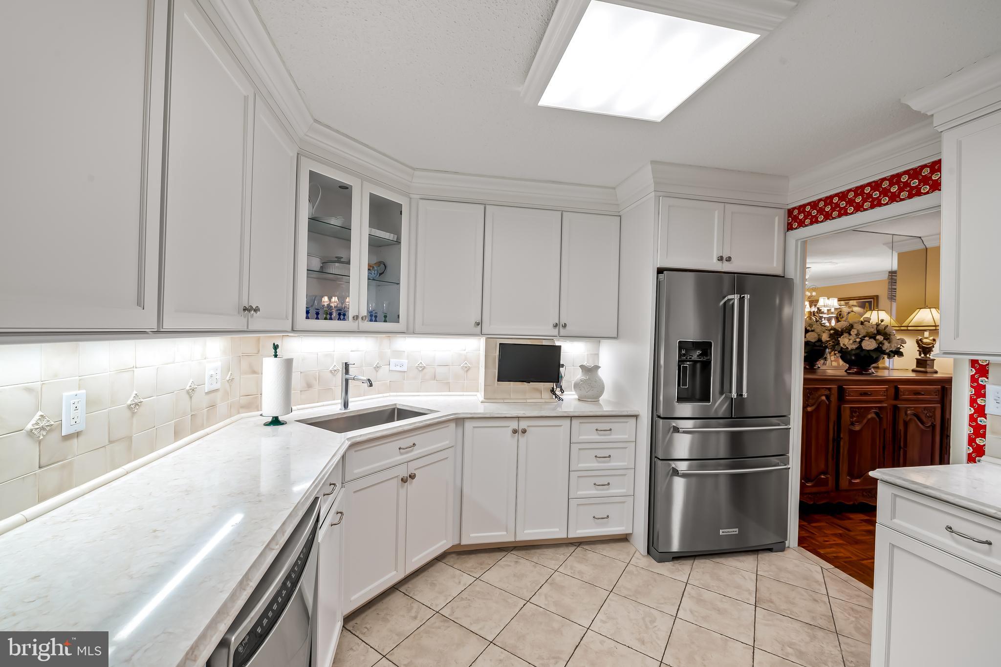 111 Hamlet Hill Road, Unit 205 Baltimore, MD 21210 - Photo 17 of 65 a kitchen with a sink cabinets and stainless steel appliances