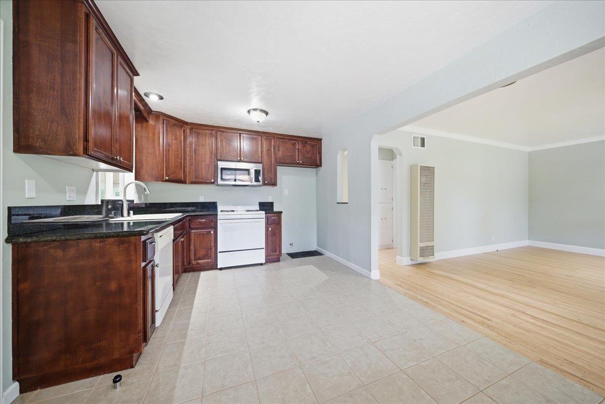 2509 Ganzan Way Rancho Cordova, CA 95670 - Photo 11 of 33 a kitchen with stainless steel appliances granite countertop a stove refrigerator sink and cabinets