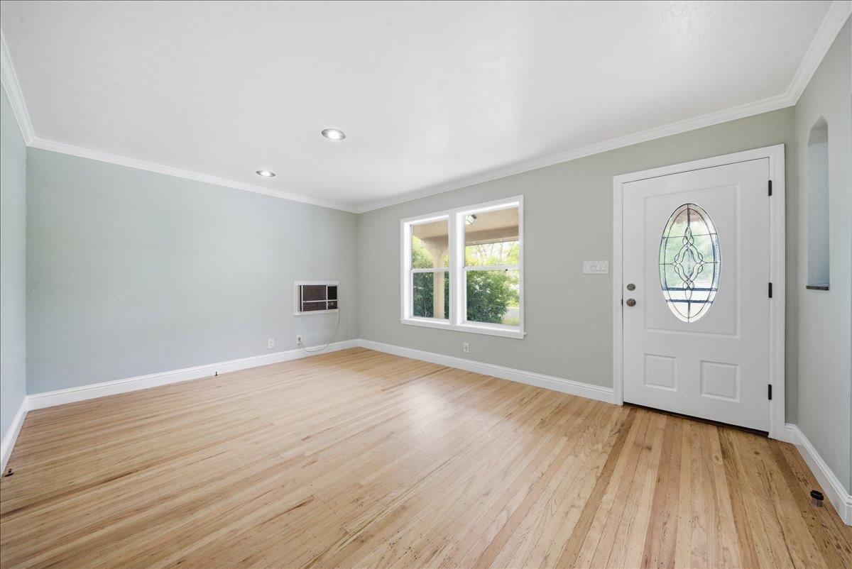 2509 Ganzan Way Rancho Cordova, CA 95670 - Photo 5 of 33 an empty room with wooden floor and windows