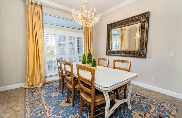 a living room with furniture kitchen view and a chandelier