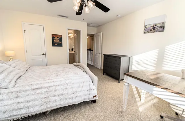 a bathroom with a granite countertop toilet and a sink