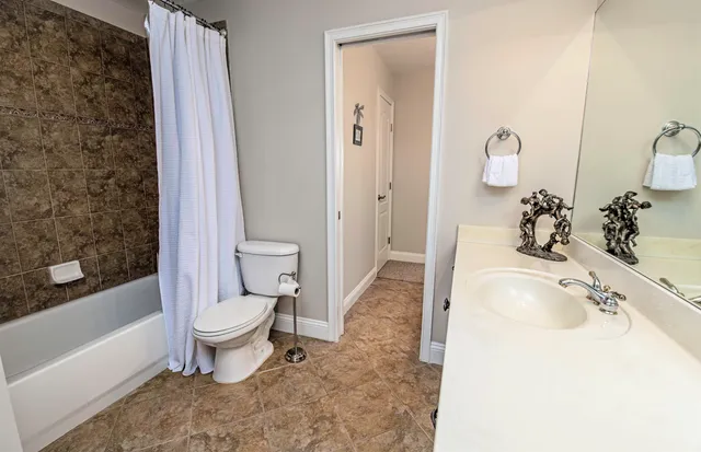 a front view of a house with a yard and a garage