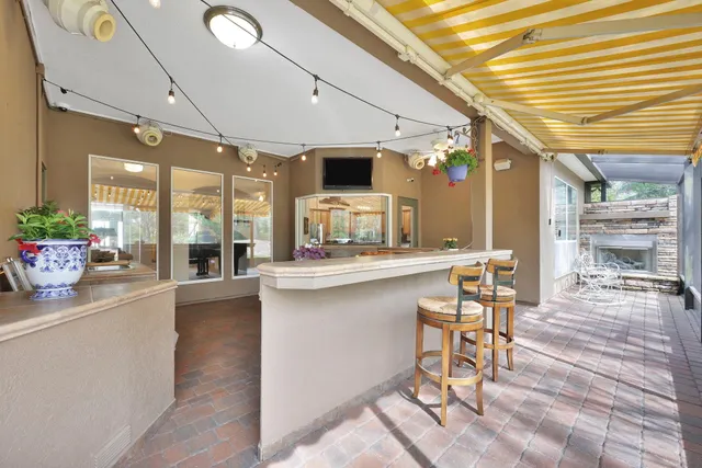 a living room with fireplace furniture and a flat screen tv