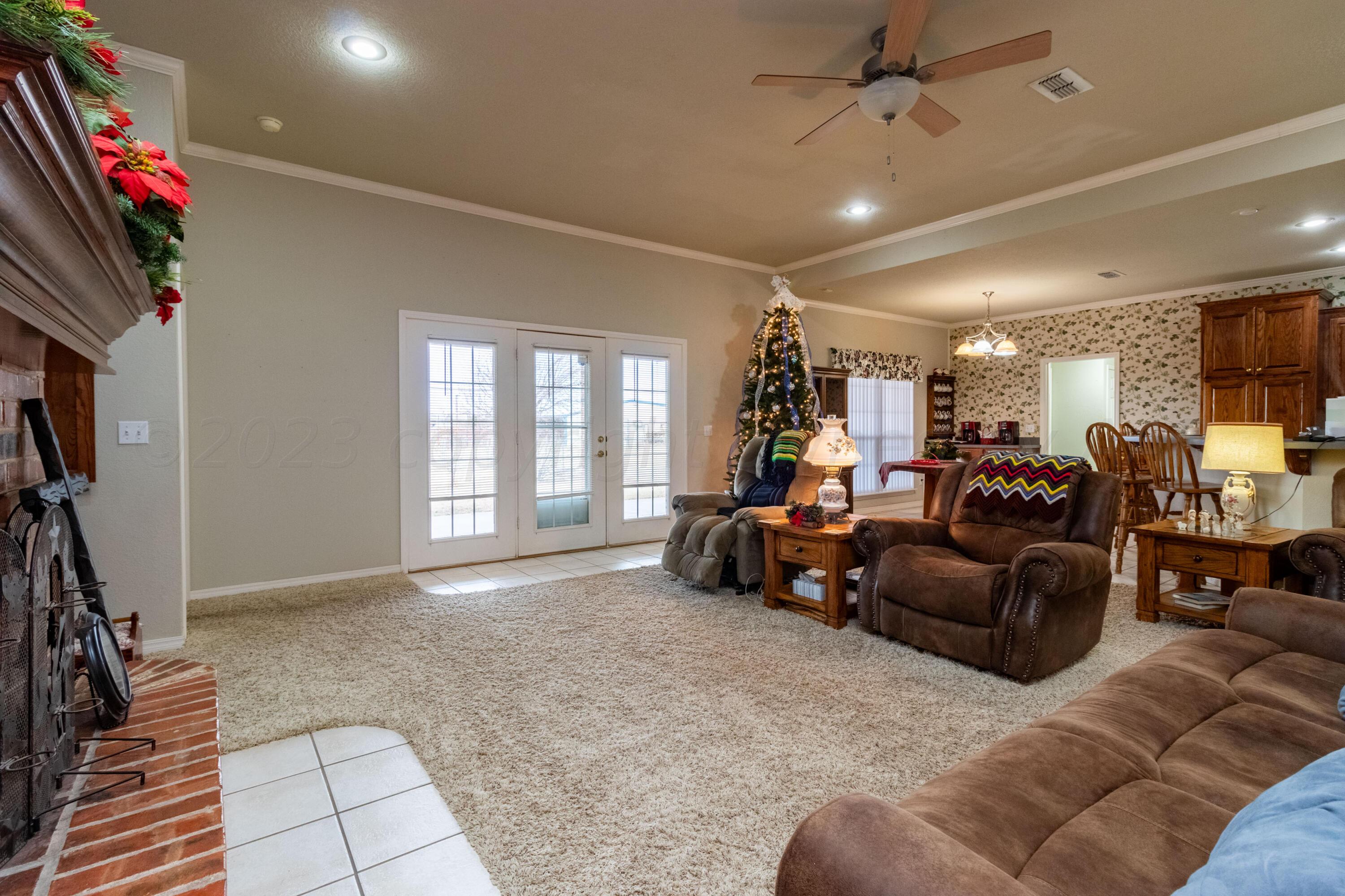 15212 Halsey Trail Amarillo, TX 79118 - Photo 11 of 47 a living room with furniture a window and a flat screen tv
