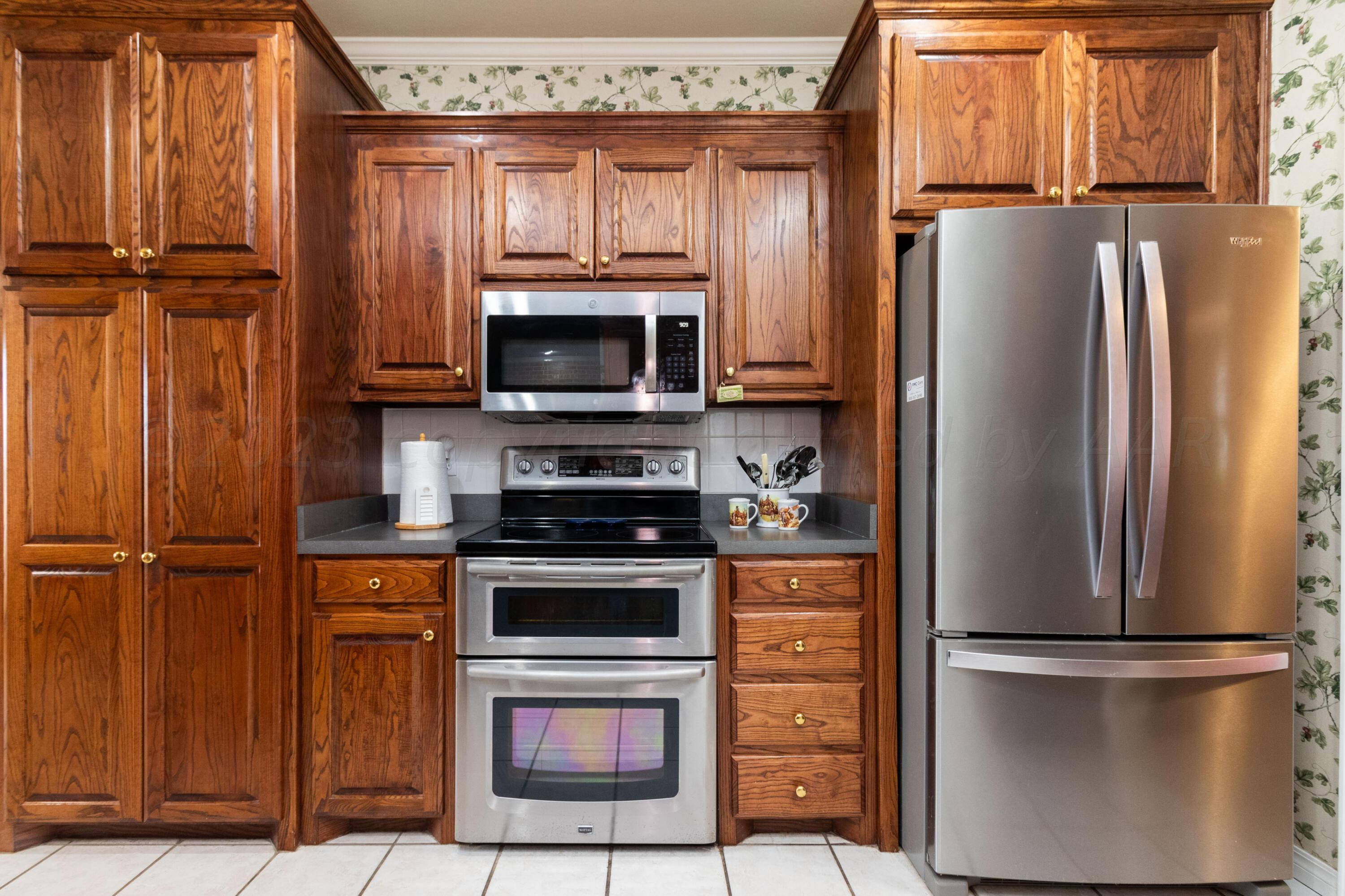 15212 Halsey Trail Amarillo, TX 79118 - Photo 15 of 47 a kitchen with stainless steel appliances a refrigerator stove and microwave