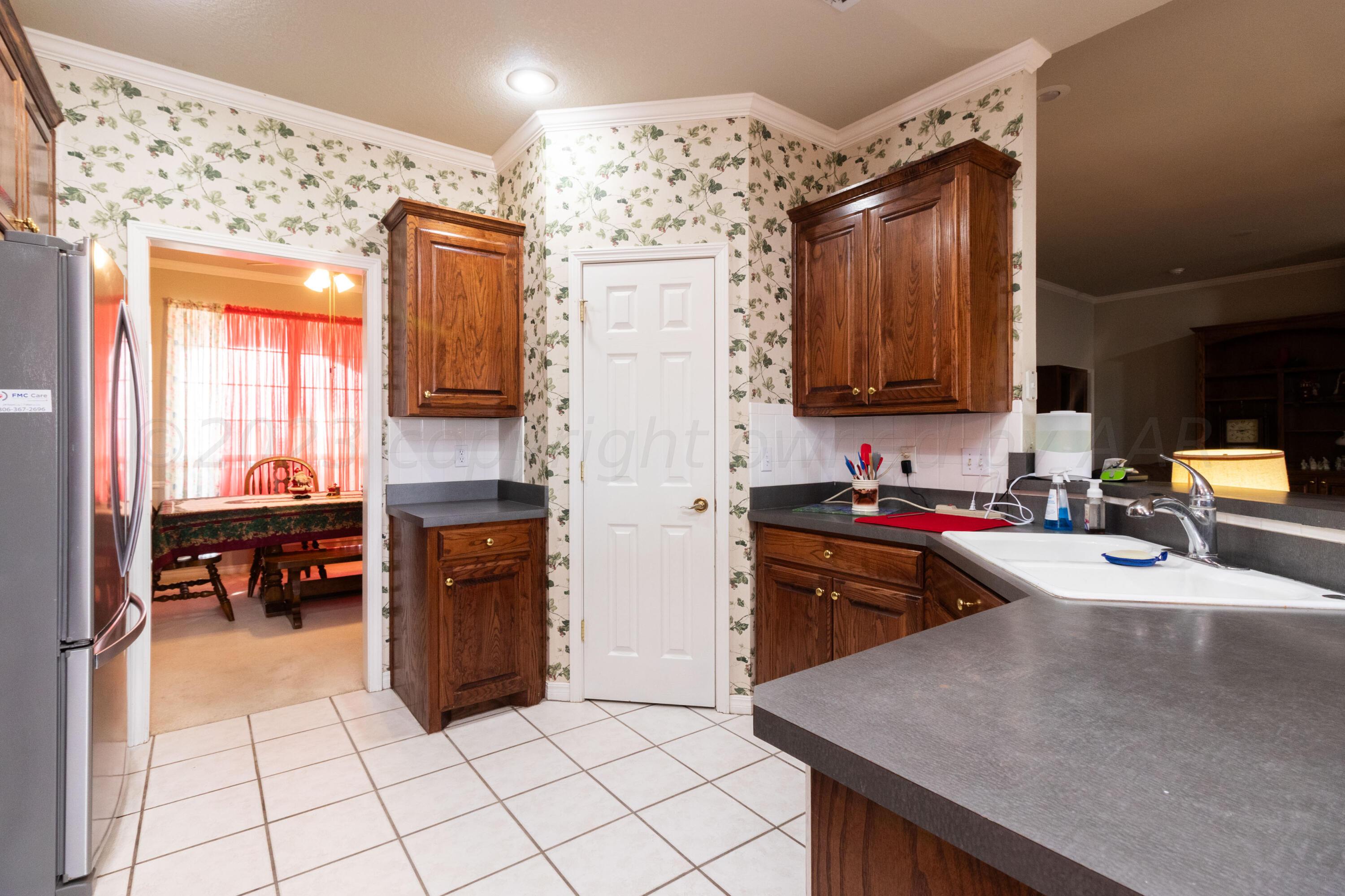 15212 Halsey Trail Amarillo, TX 79118 - Photo 16 of 47 a kitchen with granite countertop a refrigerator stove top oven and sink